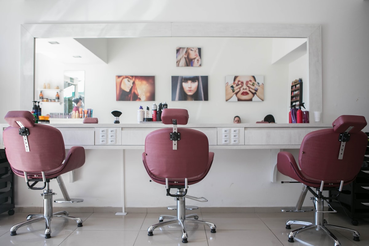Warm, relaxed interior of Iron Cut Barbers with chairs and mirrors